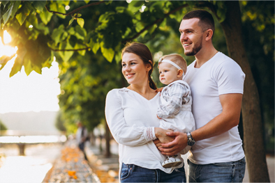 Yellow house with green trees and porch