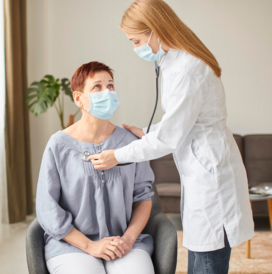 Yellow house with green trees and porch