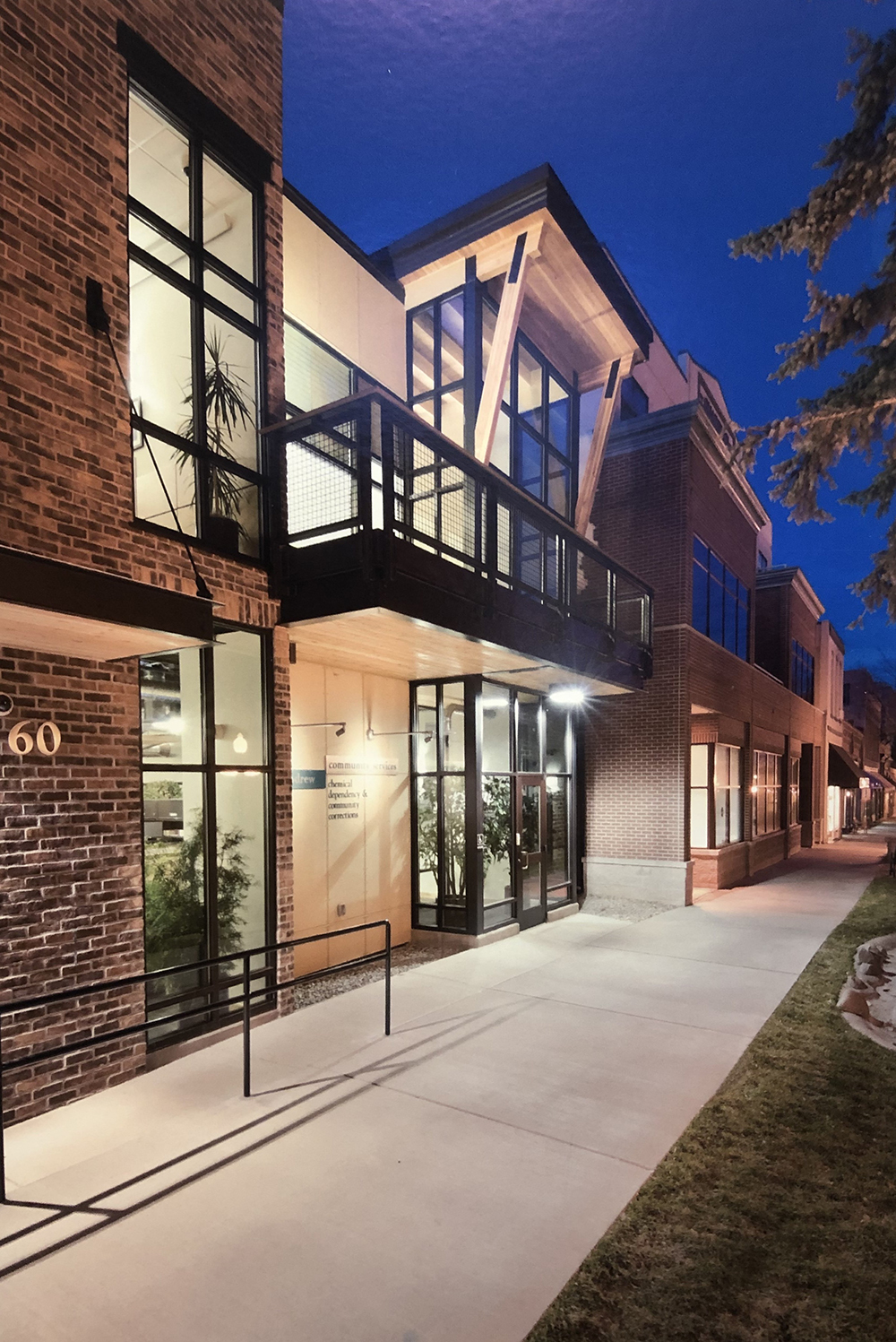 Yellow house with green trees and porch
